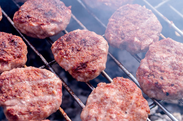 Grilling meatballs on the grill. Cooking  barbeque with charcoal in garden. Turkish cuisine. - Photo, Image