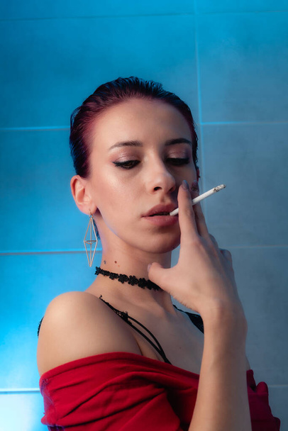 Girl smokes a cigarette. Confident lady. - Фото, зображення