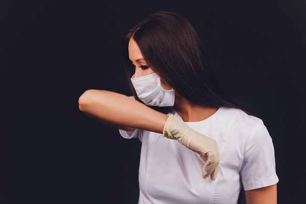 Close up woman portrait, Young woman wearing home made hygienic face medical mask to prevent infection, illness or flu and 2019-nCoV. Black background. Protection against disease, coronavirus. - Foto, imagen