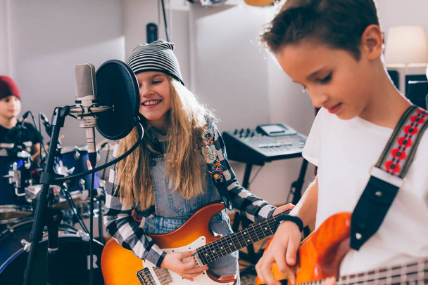kids rock band playing in music studio - Фото, изображение