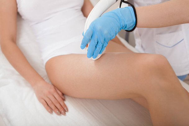 Cropped shot of unrecognizable woman getting legs hair removal laser procedure - Valokuva, kuva