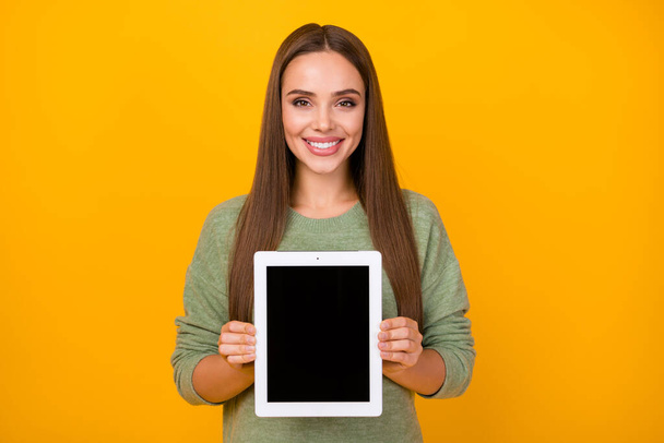 Portrait of cheerful confident cool girl hold tablet advise choose decide new gadget wear pullover isolated over vibrant color background - Photo, image