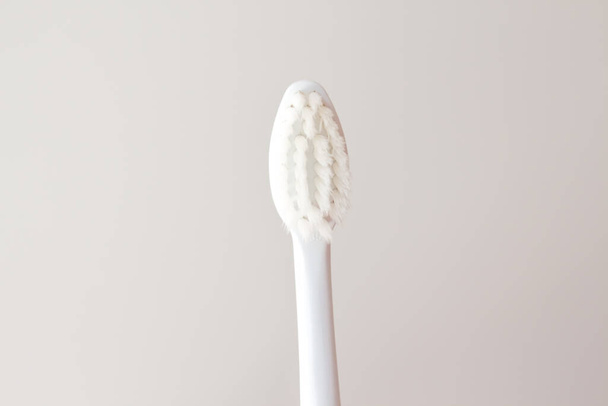 Soft toothbrush for gentle brushing on a beautiful white background close-up. Oral care layout with copy space.  - Foto, imagen