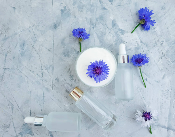 crème fleur cosmétique bleuet sur fond béton - Photo, image