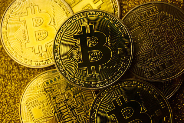 Golden bitcoin on the cool golden sparkling background. Bitcoin cryptocurrency. Crypto currency concept. - Photo, Image