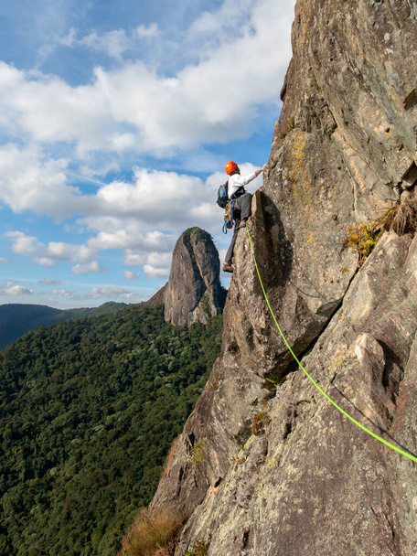 People rock climbing with Pedra do Bau on background - Photo, Image