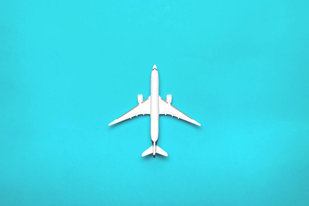Flight plane travel concept. White toy airplane, aircraft on bright blue. Air sky fly background. - Fotoğraf, Görsel