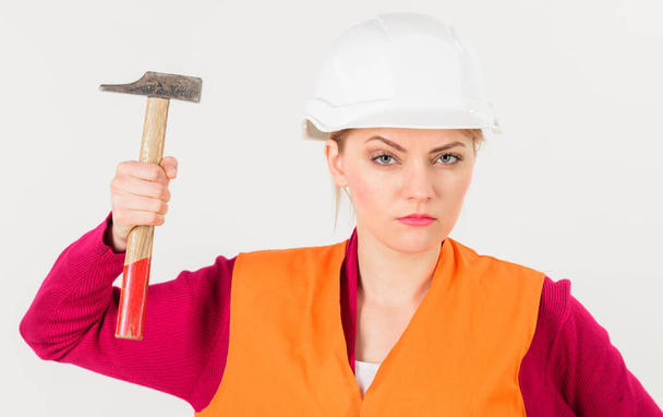 Young strong woman works as builder. Feminism concept. - Foto, immagini