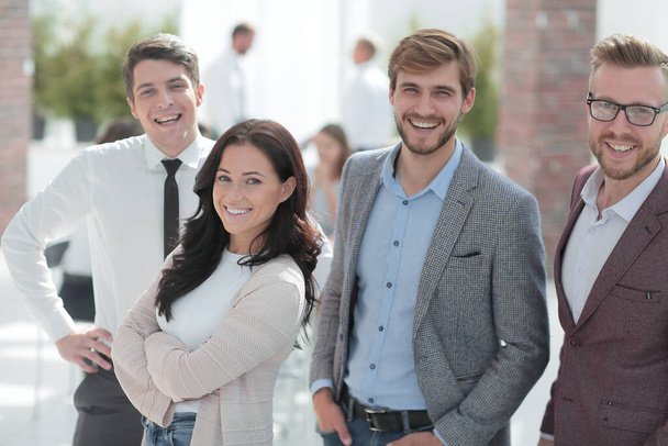 group of successful young employees standing in the office - Фото, изображение
