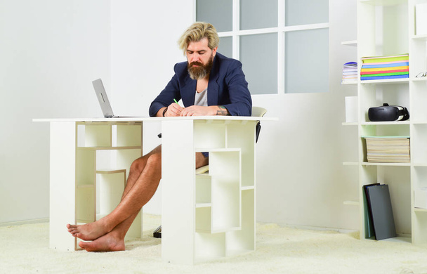 barefoot businessman work on laptop in home office. bearded man in jacket working with comfort. self education online. stay at home. lock down on coronavirus quarantine. distant business - 写真・画像