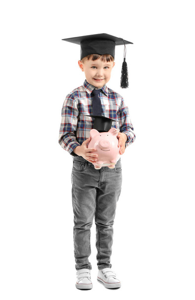 Little boy with piggy bank on white background. Concept of savings for education - Photo, Image