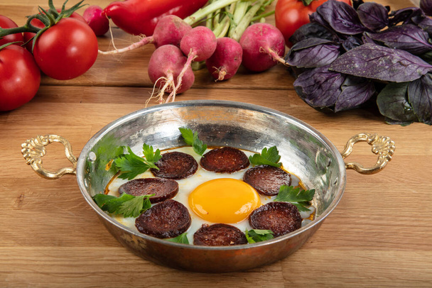 Turkish Sausage (sucuk) and egg isolated on rustic wooden table. - Photo, Image