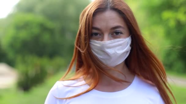 A woman removes a medical mask after a coronavirus pandemic - Video, Çekim