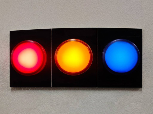 pilot lamp for showing 3 phase status of electricity by red yellow and blue lights installed on panel. - Photo, Image