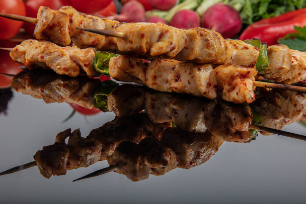 Chicken skewers. Grilled chicken on bamboo skewers, close up view, shallow depth of field. - Photo, Image