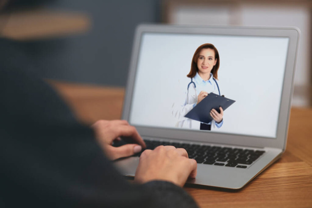 Woman using laptop for online consultation with mature female doctor, closeup  - Φωτογραφία, εικόνα