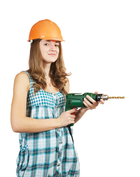 Female worker in a hard hat with drill - Fotoğraf, Görsel