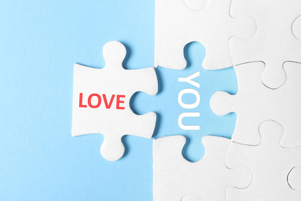 Puzzle with phrase LOVE YOU on light blue background, top view - Zdjęcie, obraz