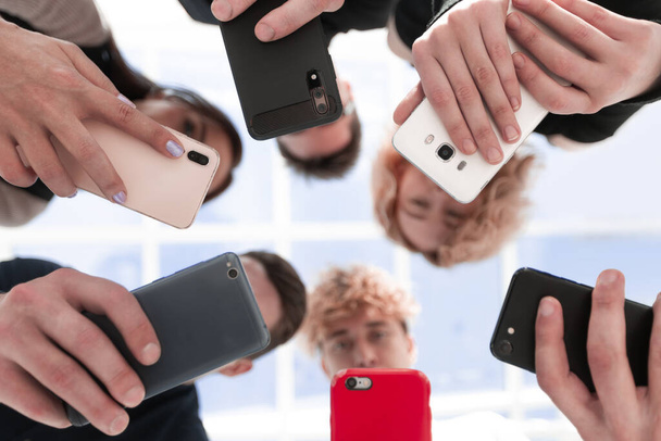 Group of businessman hold smartphones. bottom view - Foto, afbeelding