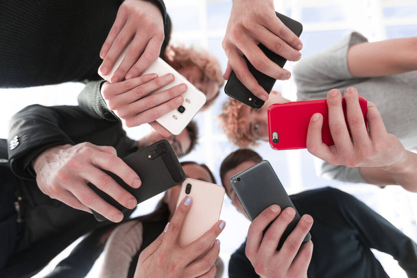 Group of businessman hold smartphones. bottom view - Фото, зображення