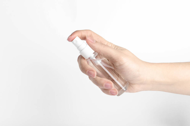 Woman holding antiseptic spray on white background, closeup - Photo, image