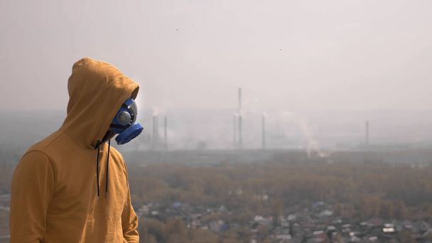 man in respirator against the background of factory chimneys - Photo, image