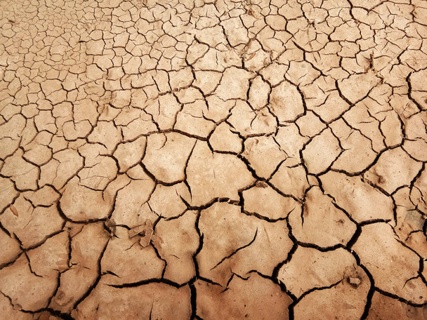 Le sol a des fissures dans la vue supérieure pour le fond ou la conception graphique avec le concept de sécheresse et de mort. - Photo, image