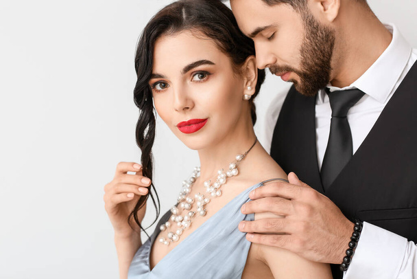 Young couple wearing stylish accessories on light background - Photo, Image