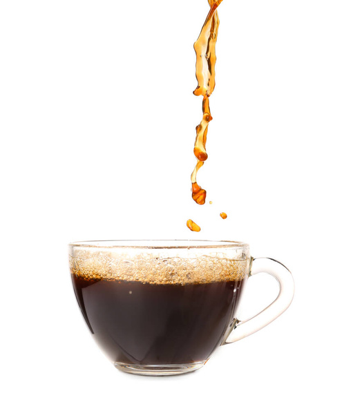 Pouring of hot coffee in cup on white background - Fotó, kép