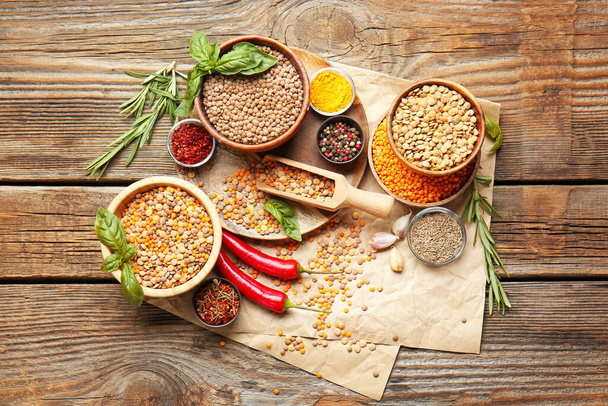 Different raw lentils with spices on table - Φωτογραφία, εικόνα