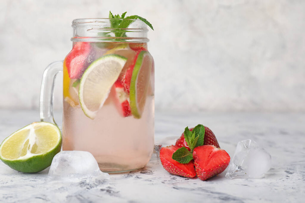 Mason jar of fresh strawberry lemonade on table - Photo, Image