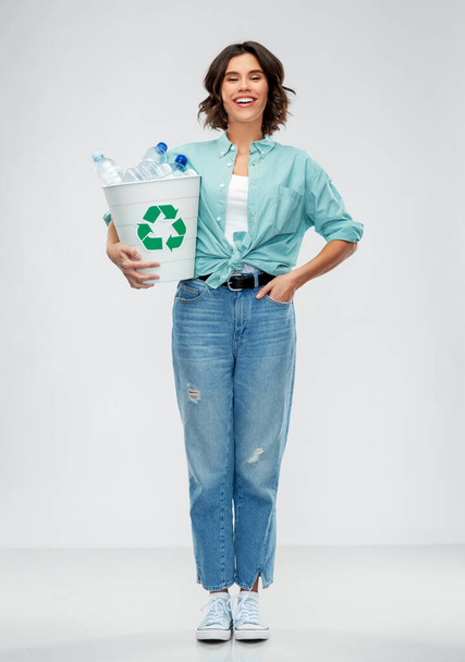 smiling young woman sorting plastic waste - Φωτογραφία, εικόνα