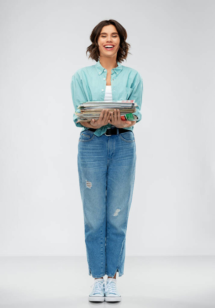 smiling young woman sorting paper waste - Foto, Bild