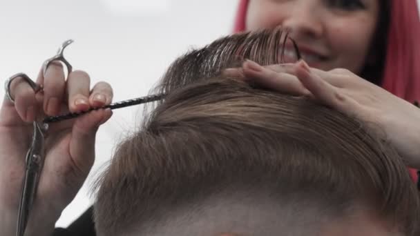 Professional female hairstylist combing and cutting man hair. Slow motion - Footage, Video