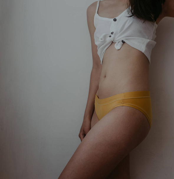 woman hips in yellow lingerie - Foto, Imagem