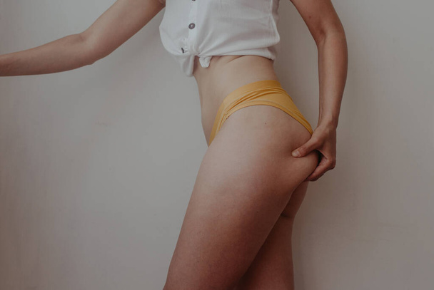 woman hips in yellow lingerie - Photo, Image