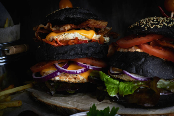 black burgers in the cut on a dark background close-up - Photo, image