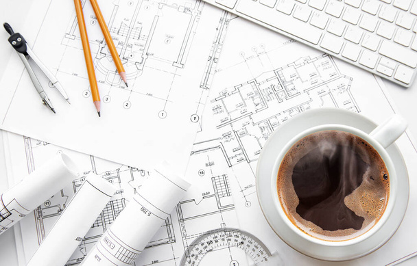 Architect workplace top view. Architectural project, blueprints, blueprint rolls on table. Construction background. Engineering tools. Copy space - Фото, зображення