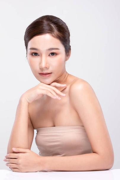 Beautiful Young Asian Woman Looking While Touching Chin feeling so happy and cheerful with healthy Clean and Fresh skin on white ,Plastic Surgery chin,Beauty Cosmetics and spa facial treatment Concept - Fotografie, Obrázek