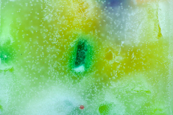 Colorful background, candle macro, air bubbles and wax, texture and wallpaper. Mixed and multicolored. - Photo, Image