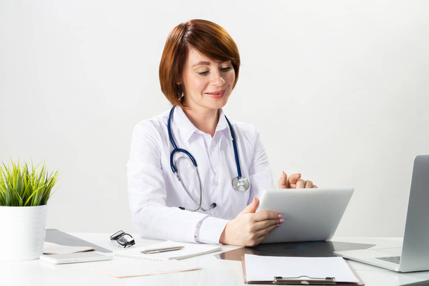Beautiful doctor using tablet computer - Photo, image