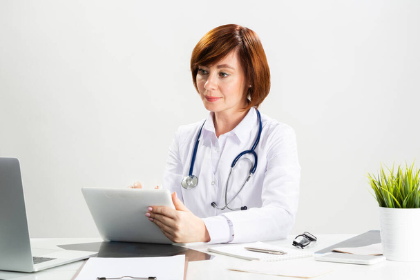 Beautiful doctor using tablet computer - Photo, image