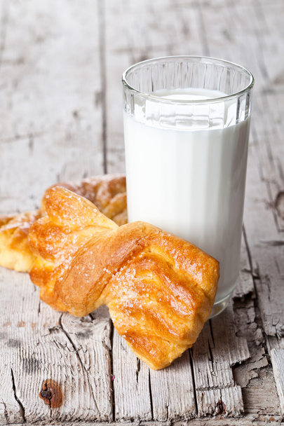 glass of milk and two fresh baked buns - Фото, изображение