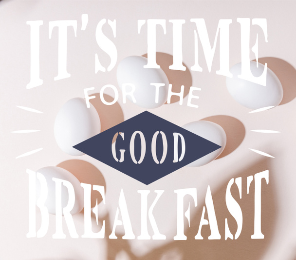 top view of white boiled chicken eggs on grey table with it is time for the good breakfast lettering   - Фото, изображение