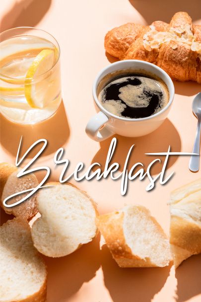 cup of coffee, croissant, water and baguette on beige table with breakfast lettering  - Photo, image