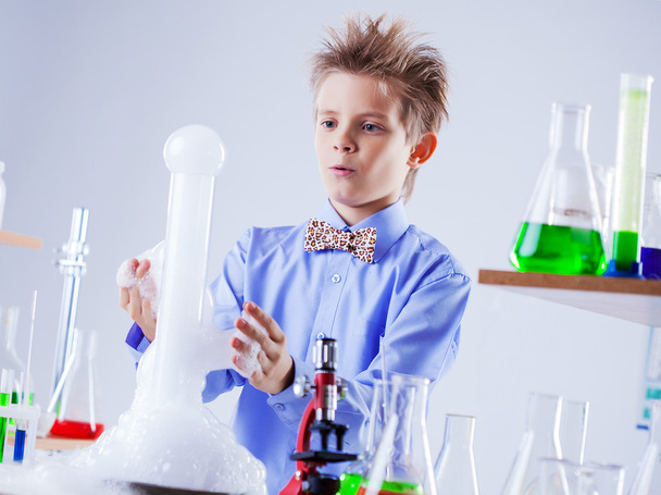 Nosy schoolboy watching reaction of experiment - Photo, image