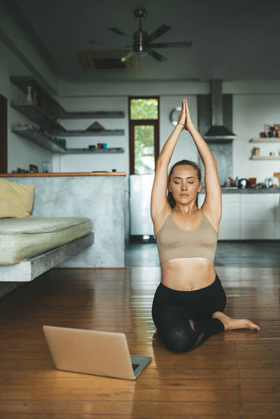 Woman practicing home yoga. Meditation. lifestyle concept - Фото, изображение