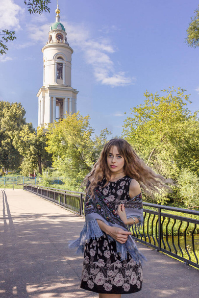 Russian girl near the church in a headscarf. - Foto, Imagen