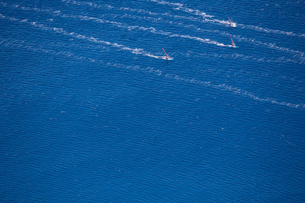 Birds eye view of skilled windsurfers enjoying strong winds - Photo, Image