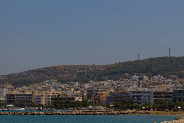 Rethymno, Greece - July  30, 2016:  Panoramic view to Rethymno from the Venetian harbour. Rethymno is a city of approximately 40,000 people in Greece, the capital of Rethymno regional unit on the island of Crete. - Photo, Image